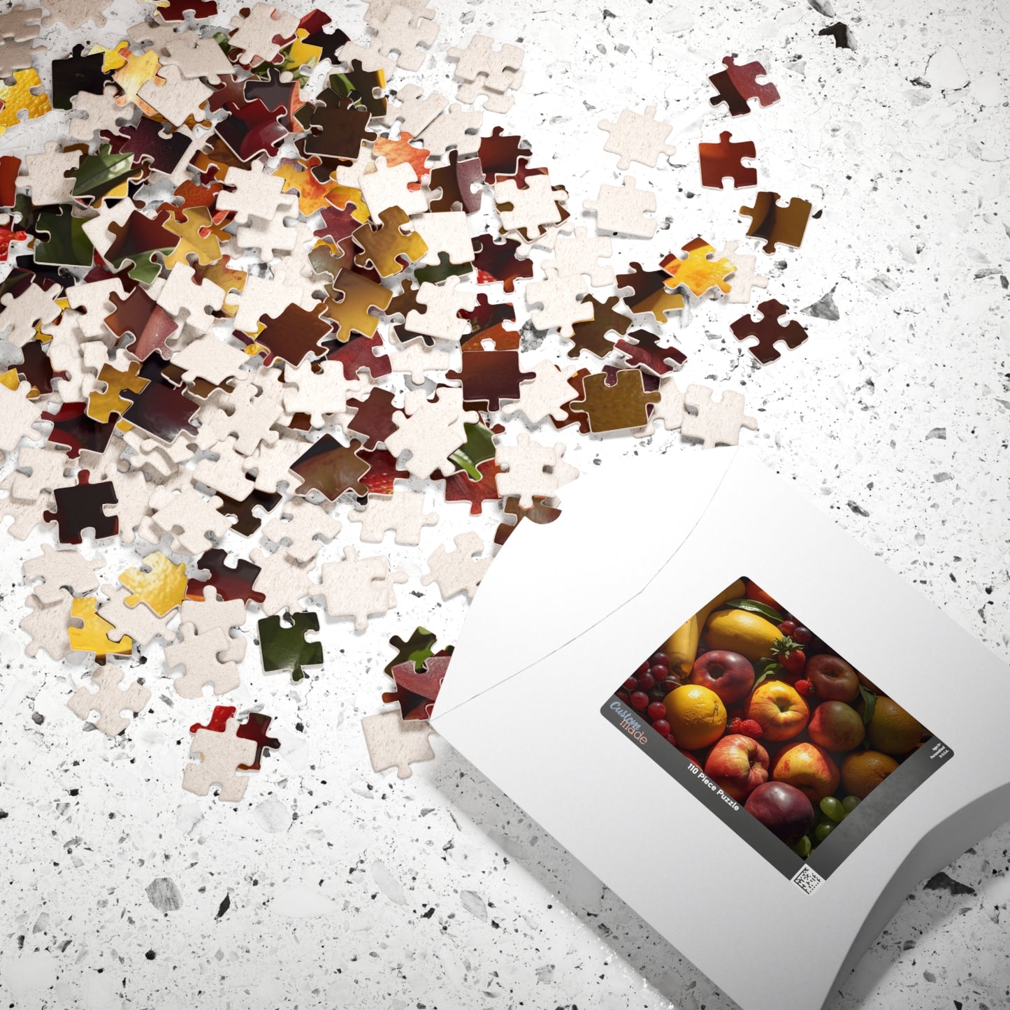Jigsaw puzzle with completed pieces and a box of assorted fruits on a speckled surface