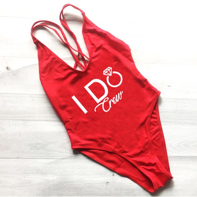 Red swimsuit on a light wooden surface