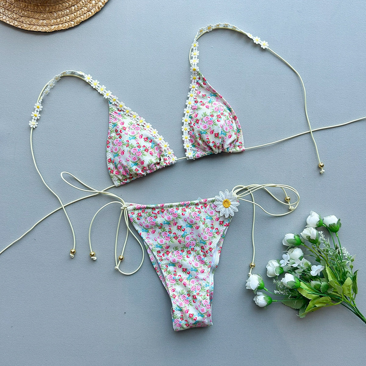 Two-piece bikini laying on a plain background