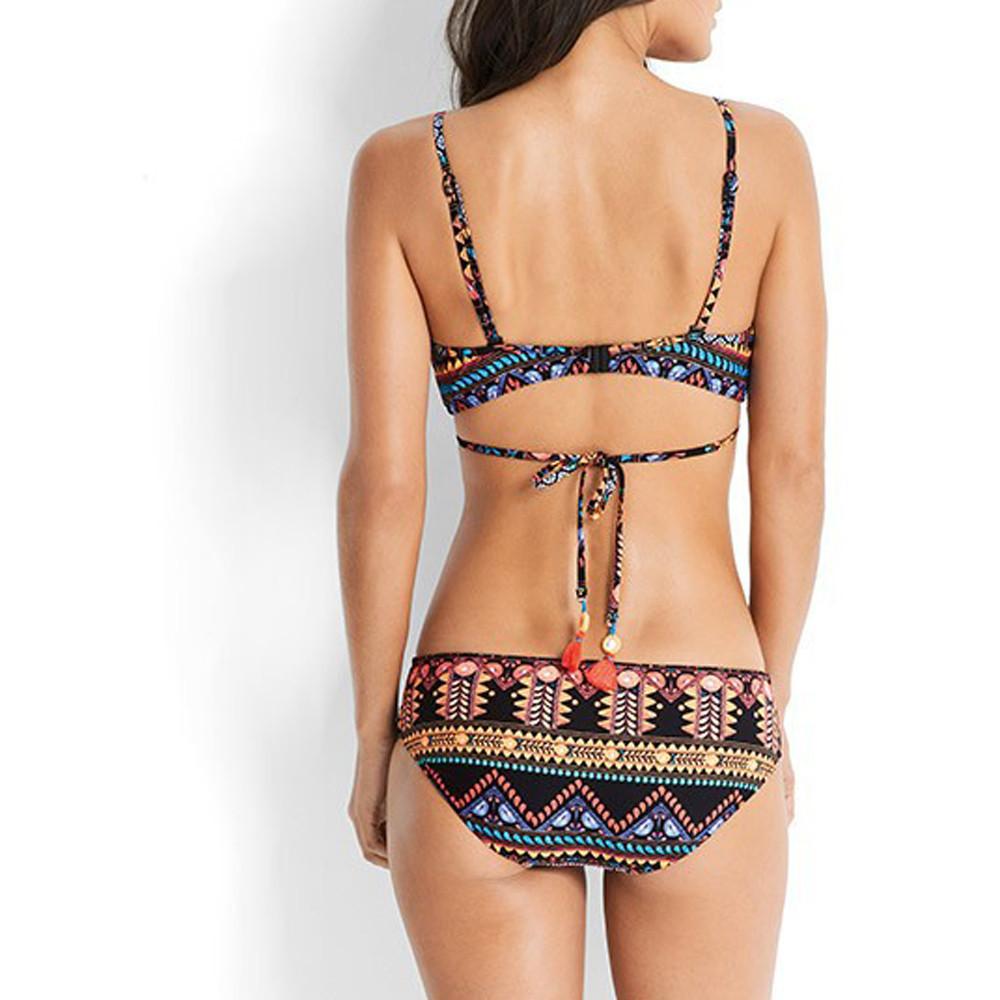 Flat lay of two‑piece bikinis set on white background showing top and bottoms.