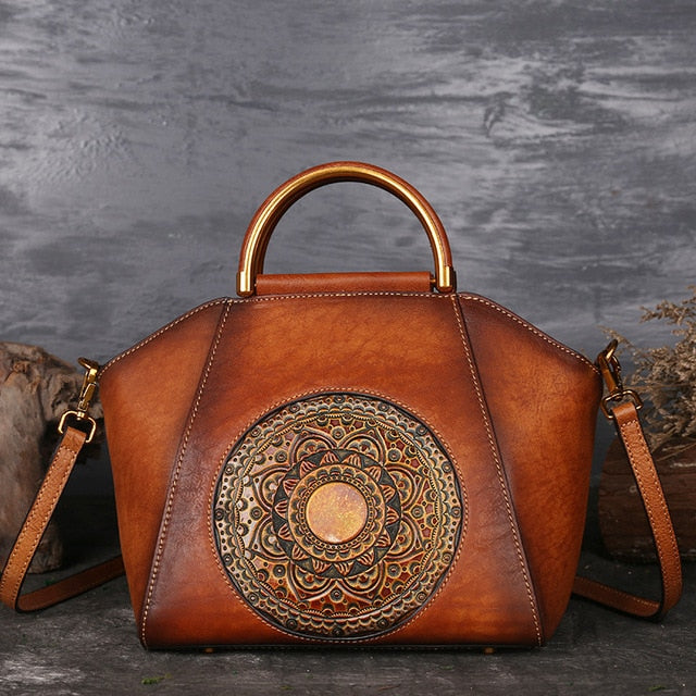 Brown genuine cow leather handbag with natural grain finish.