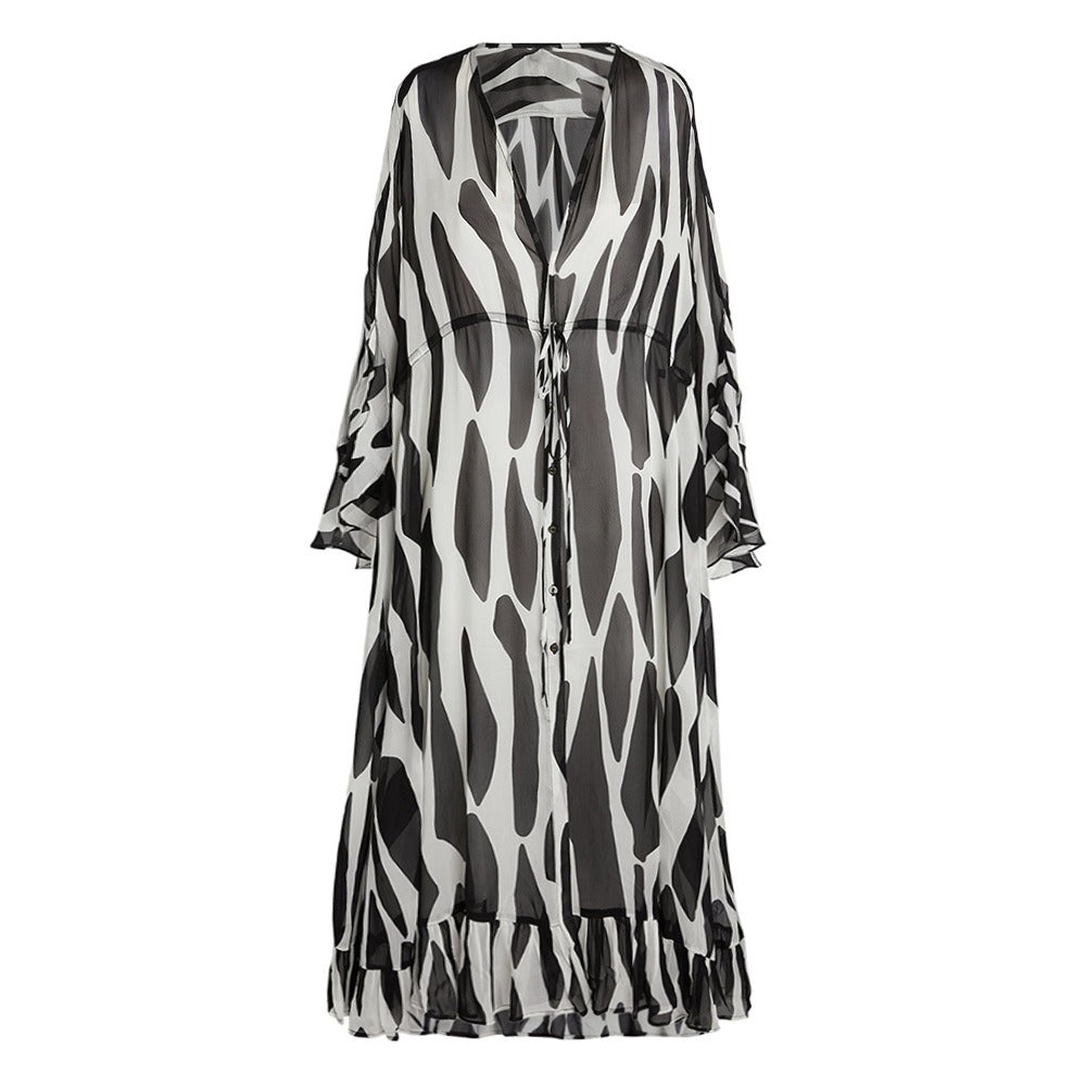 Lightweight black and white beach cover‑up robe with a split color design laid flat.