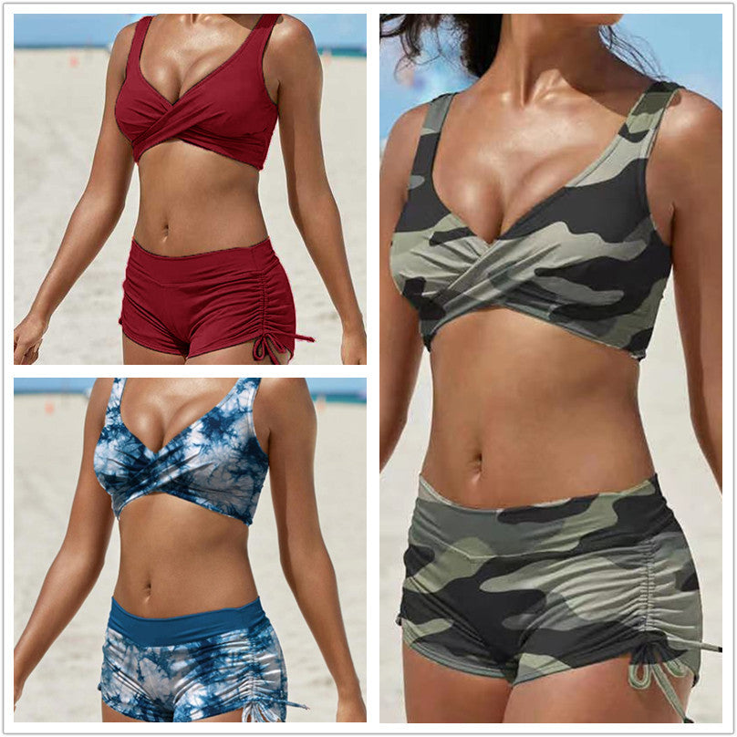 Two‑piece swimsuit available in a variety of colors featuring a crisscross bra‑style top with adjustable straps and athletic‑style high‑waist shorts with string tie closures at the sides for a secure, comfortable fit.