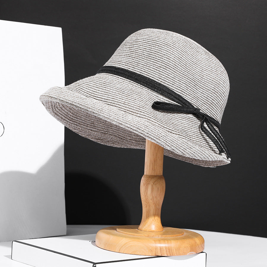 Close-up of a straw hat with a blue band on a white background