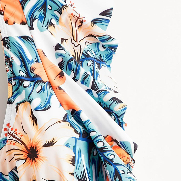 Backless short‑sleeve one‑piece swimsuit with fragmented flowers print; polyester shell 82% polyester fiber, 100% polyester lining, chest pad without steel support, quick‑drying, highly elastic, widened and thickened panels, ideal for fitness, cycling, and water sports.