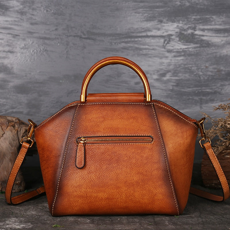 Tan genuine cow leather handbag with polished hardware.