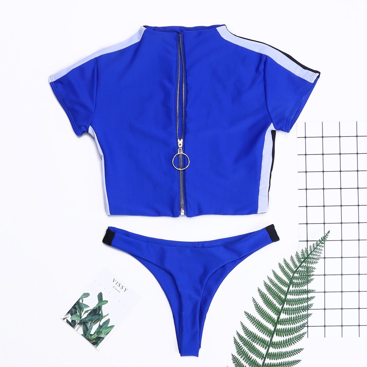 Women’s short‑sleeve two‑piece swimsuit with a front zip‑up top and matching bikini bottoms, shown in a solid color on a plain background.