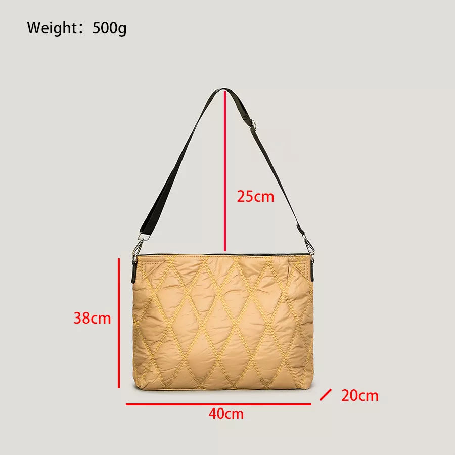 Beige quilted handbag with measurements on a gray background