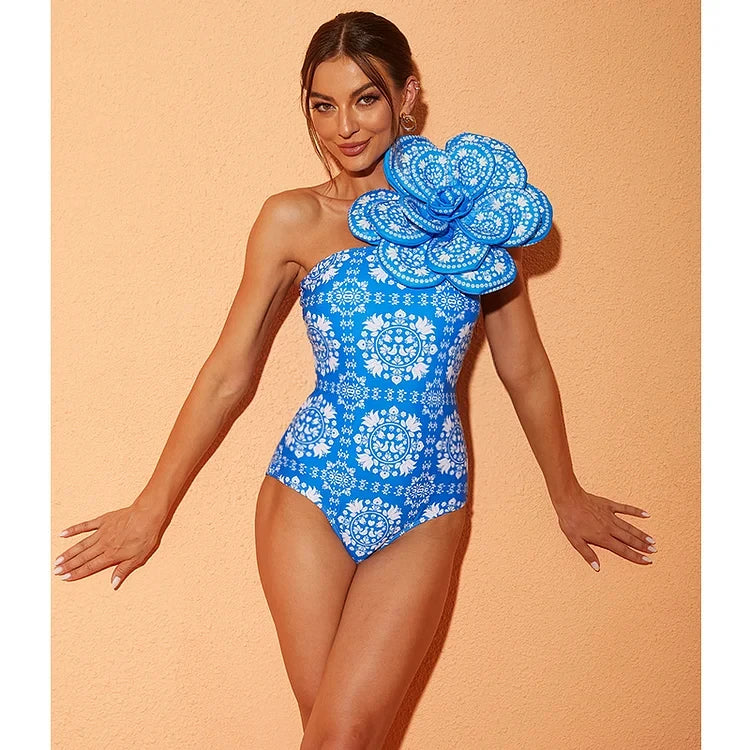 Woman wearing a blue floral swimsuit against a peach background