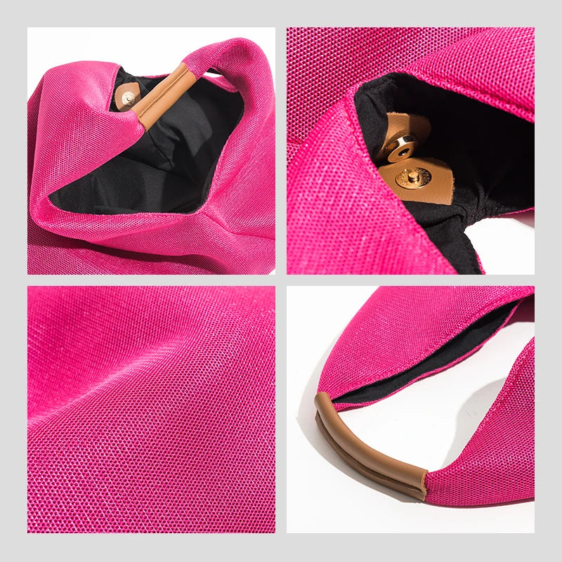 Close-up of a pink bag with a brown handle, showing texture and material details.