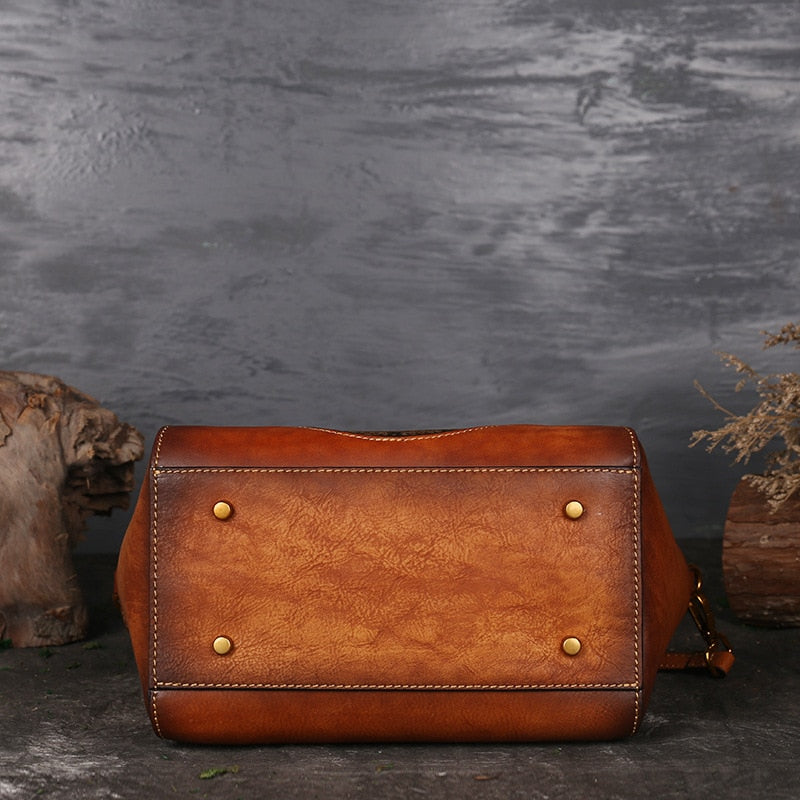 Tan genuine cow leather handbag with polished hardware.