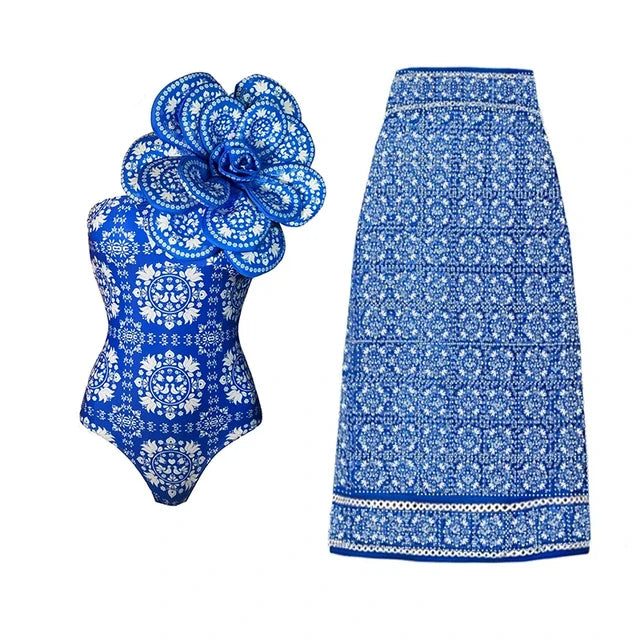 Blue floral one-piece swimsuit and skirt cover-up against a white background
