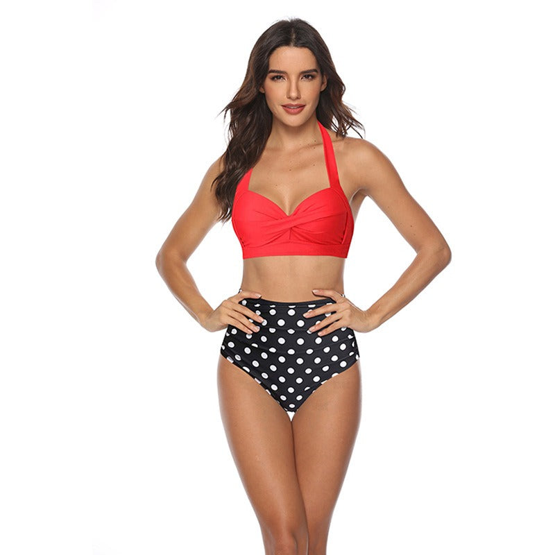 Woman wearing a multi-colored design swimsuit against a white background.