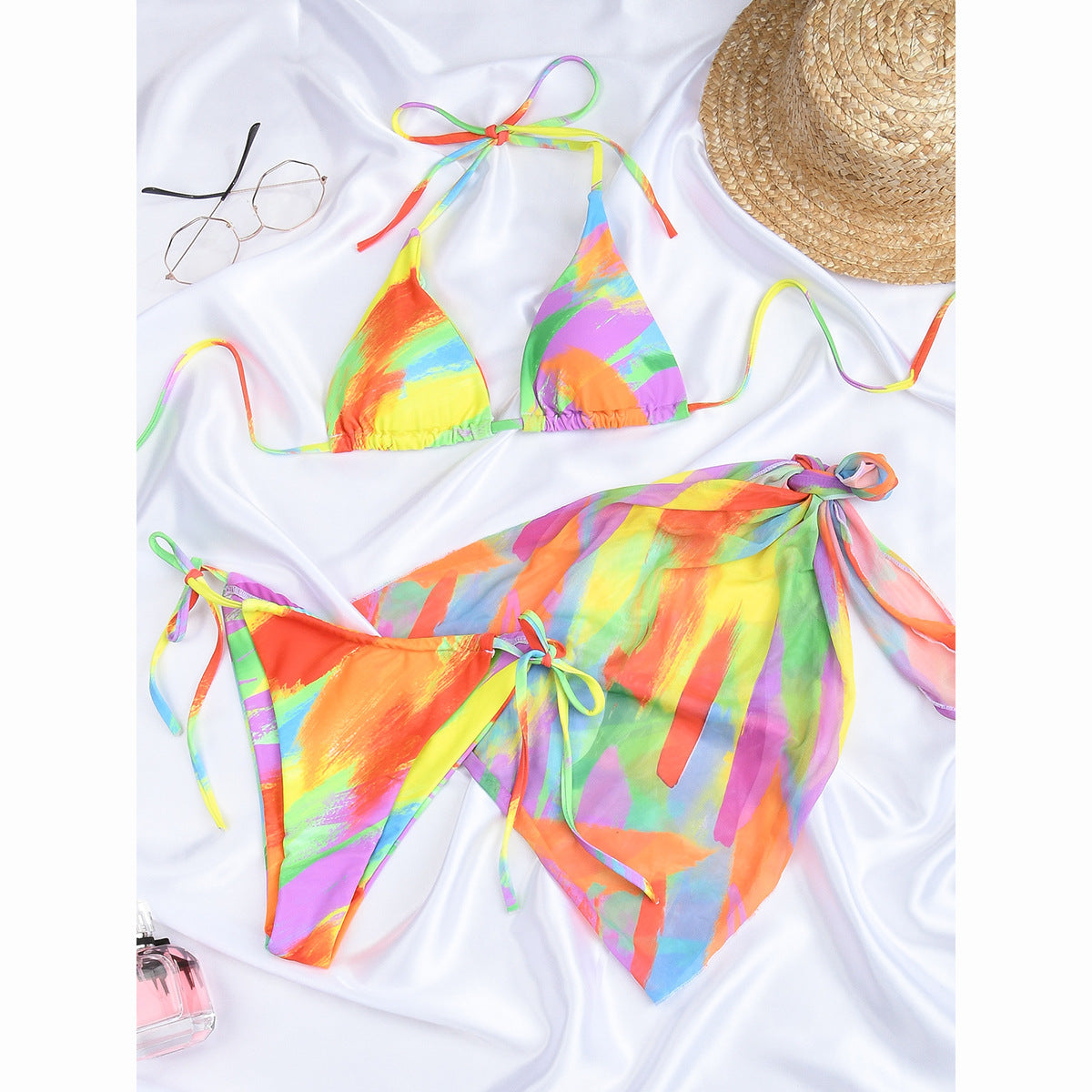 Colorful three‑piece swimwear: bandeau tube top, coordinating printed bottoms, and a lightweight wrap skirt with tie closure, ideal for pool or resort wear.