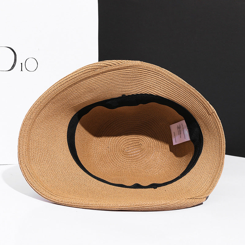 Close-up of a straw hat with a blue band on a white background