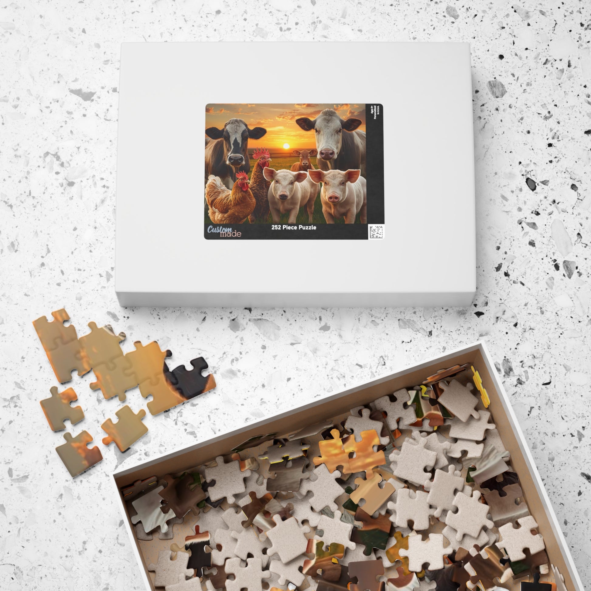 Jigsaw puzzle with completed pieces and a box of unpuzzled pieces on a textured surface