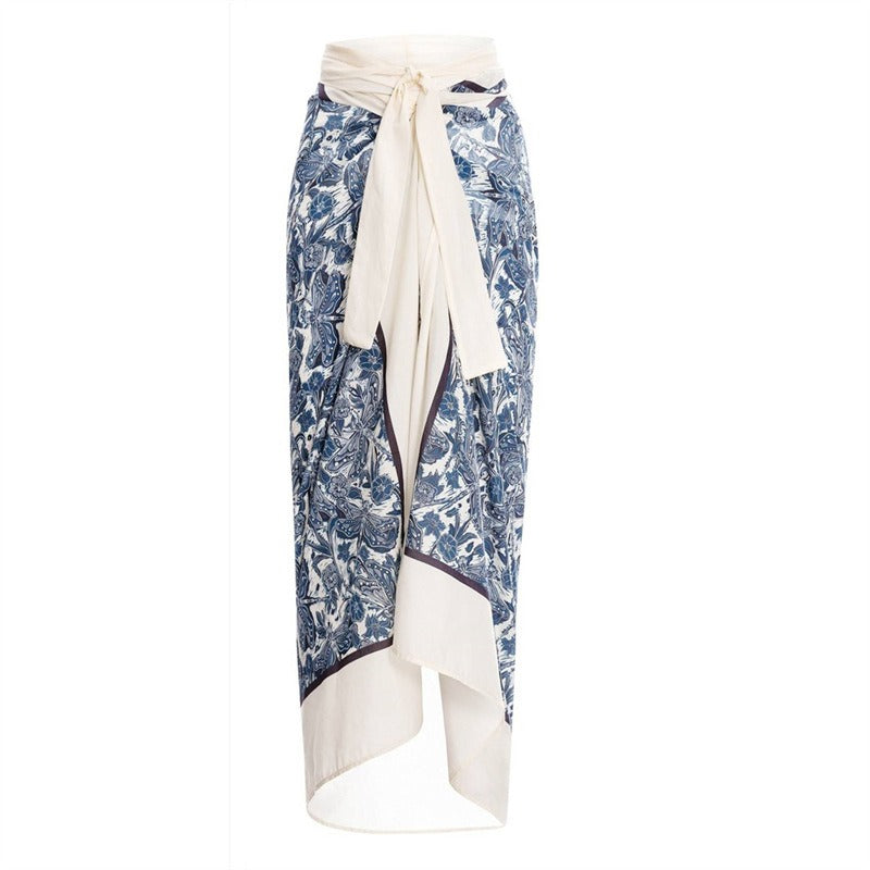 Blue floral skirt coverup with a white belt on a white background