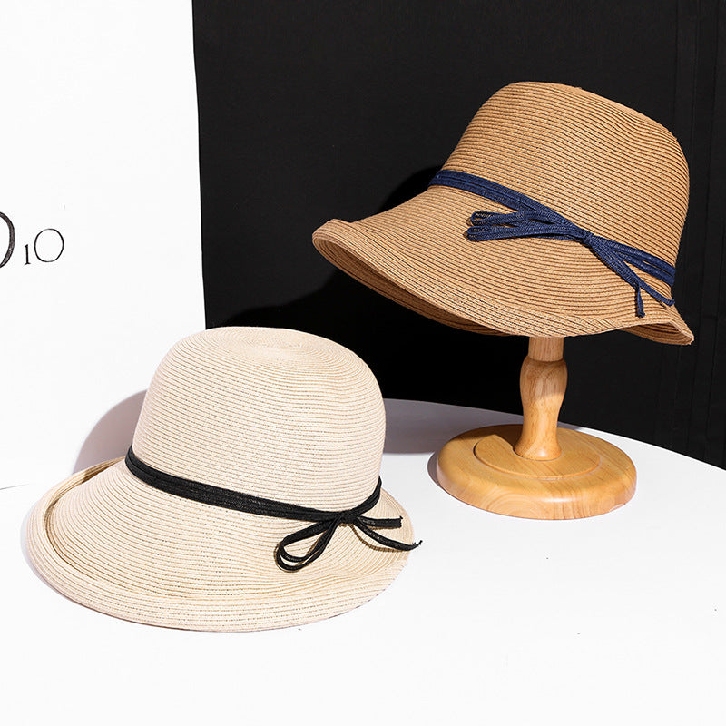 Close-up of a straw hat with a blue band on a white background