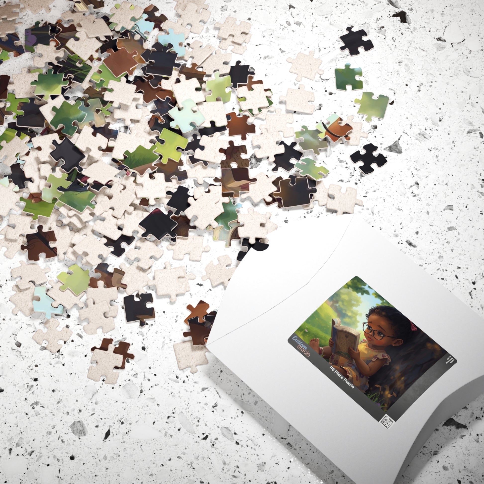 Jigsaw puzzle with a box showing a completed puzzle design on a speckled surface