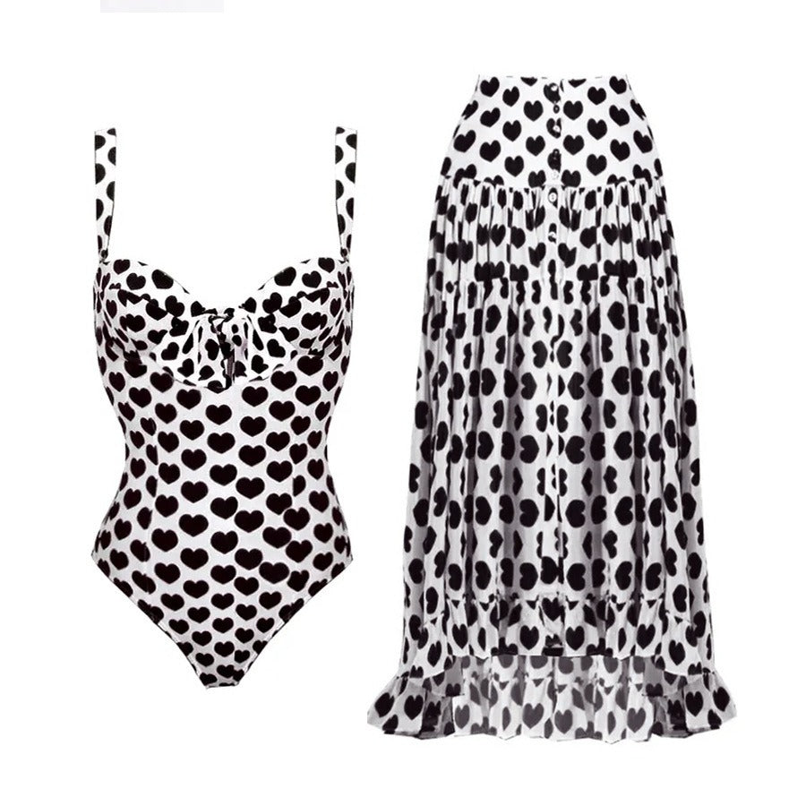Retro printed one‑piece swimsuit with a matching flowing skirt cover‑up.