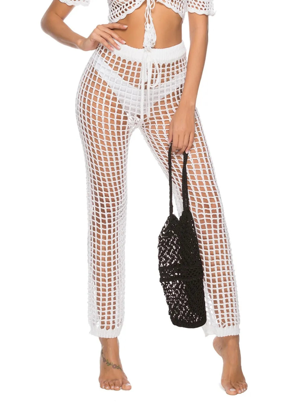 High‑waist cutout swim cover‑up pants with tie‑up closure in a solid color, displayed on a plain background.