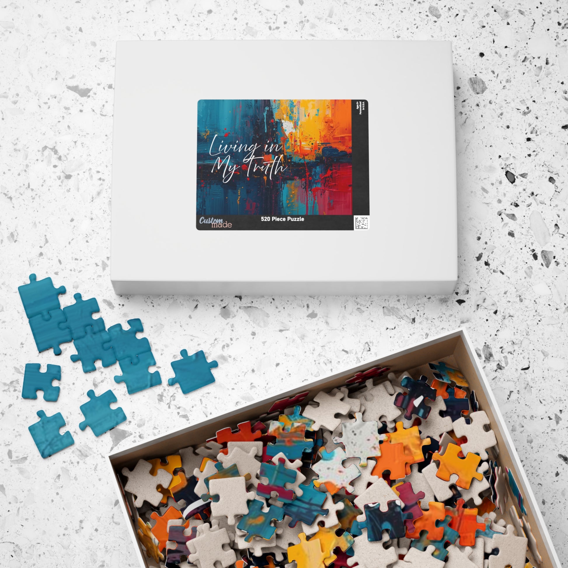 Puzzle set with colorful pieces and packaging on a textured surface