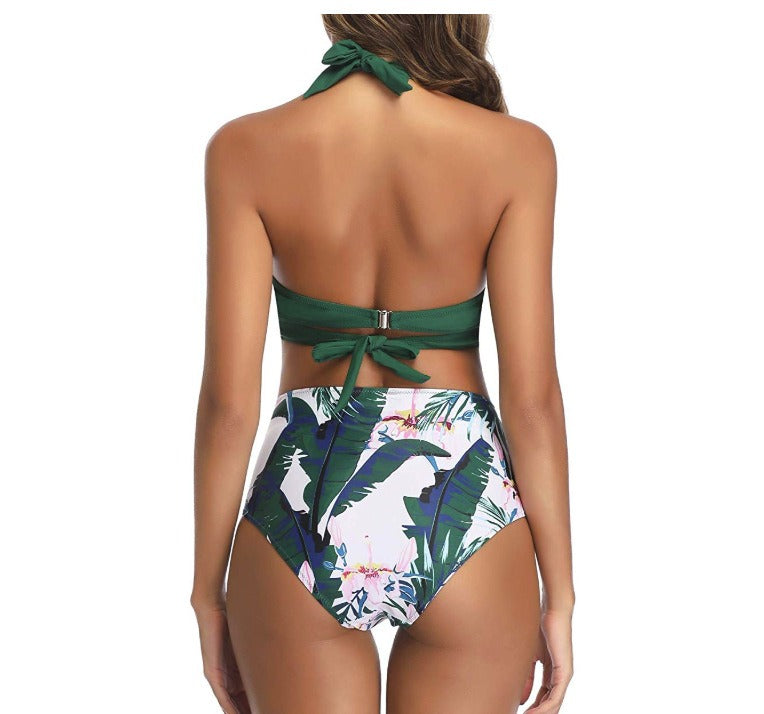 Woman wearing a multi-colored design swimsuit against a white background.