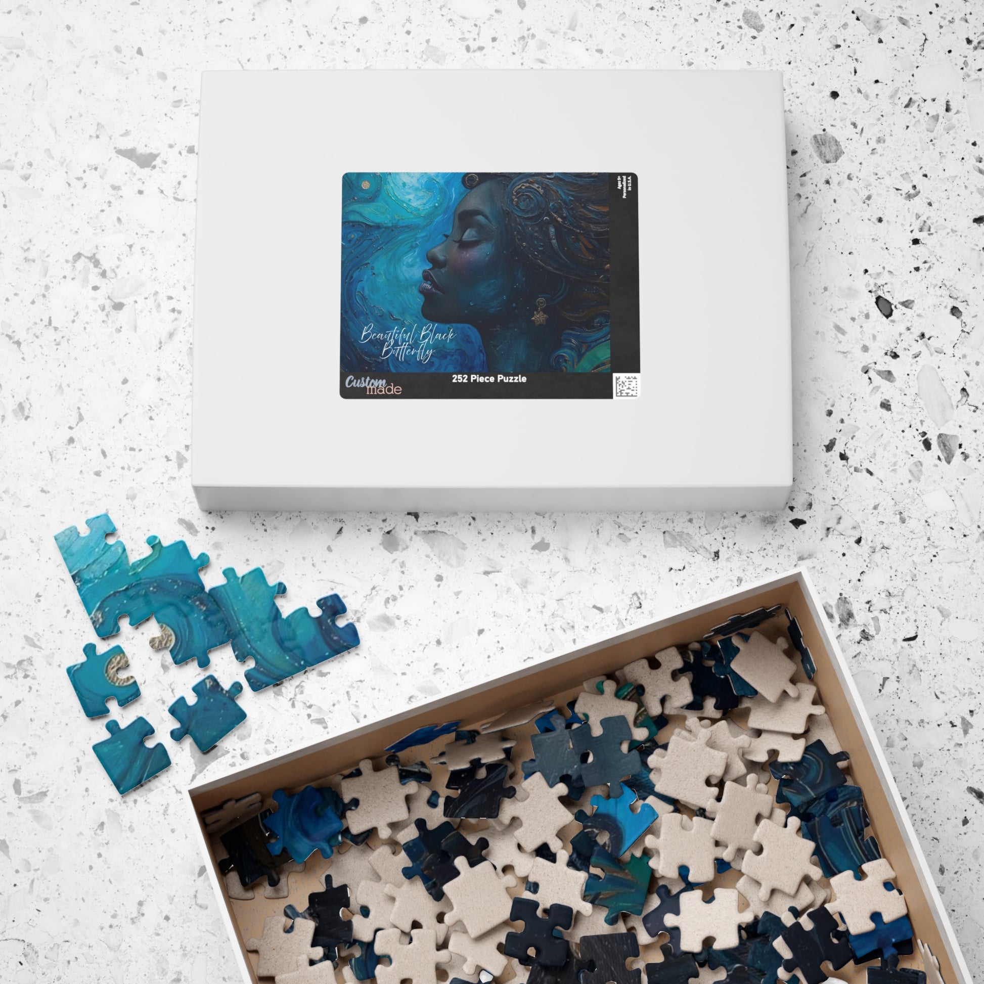 Jigsaw puzzle set with pieces and packaging on a textured surface