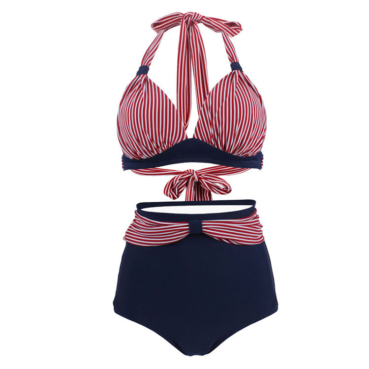 Woman wearing a red candy cane striped halter bikini top and high‑waisted blue bottoms.
