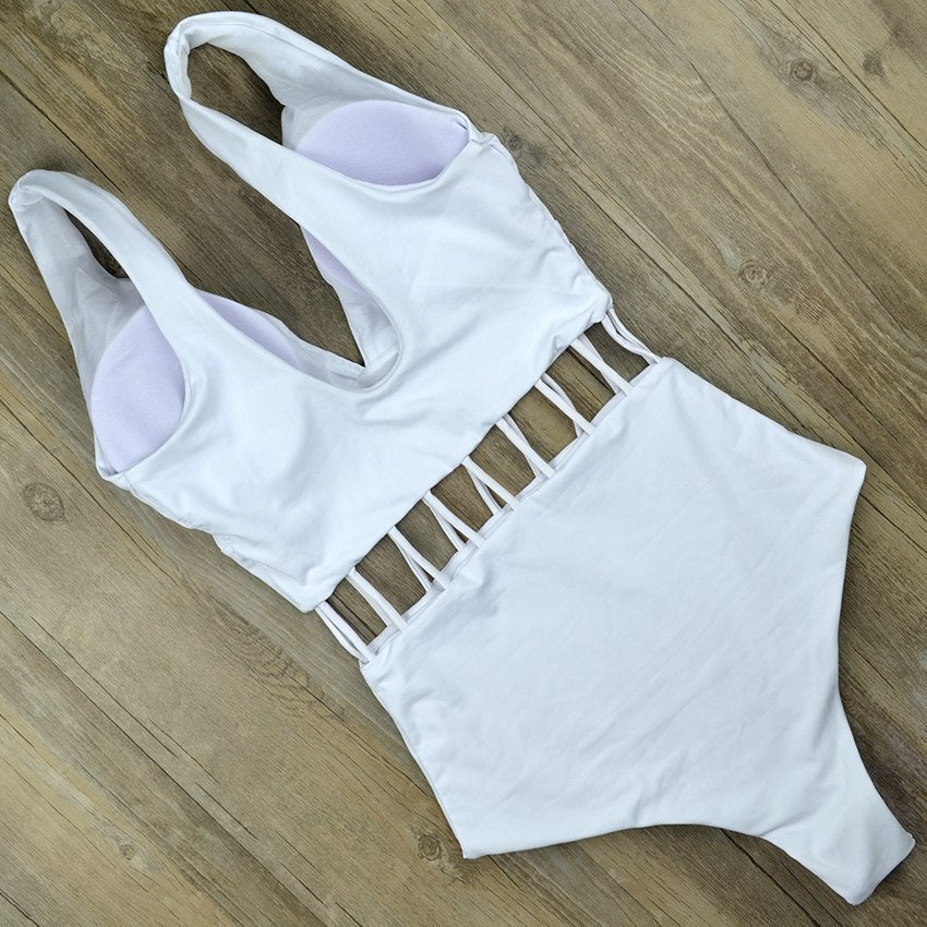 White V‑neck one‑piece monokini with hollow cut‑outs at the waist, sleeveless design, displayed on a plain background.