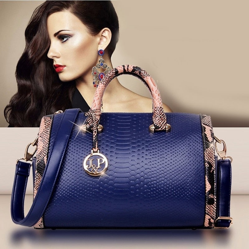 Women’s luxury faux‑leather snakeskin crossbody handbag with top handle and shoulder strap.