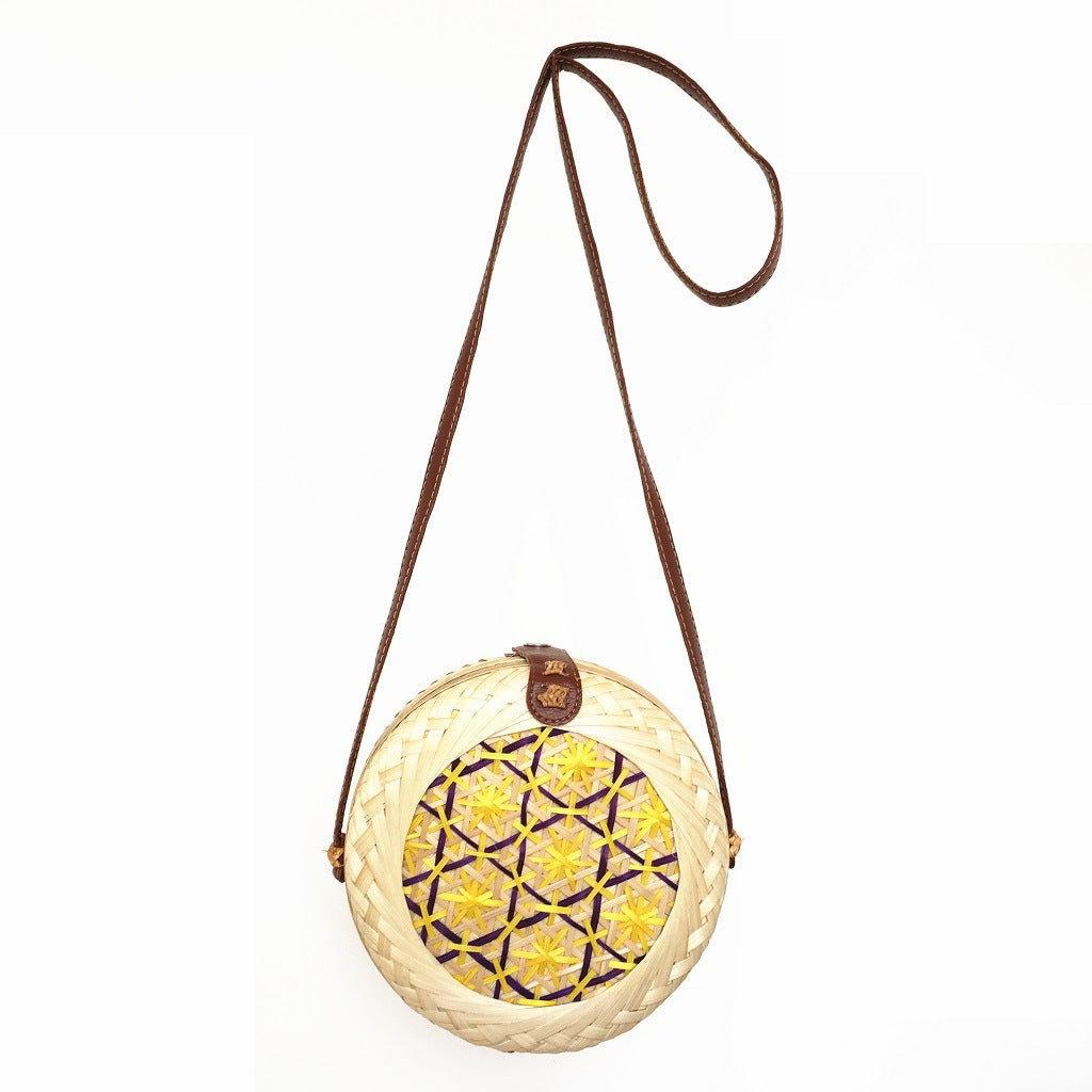 Woven basket with decorative lid on a white background