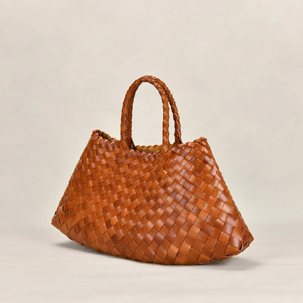 Brown woven handbag on against a plain background