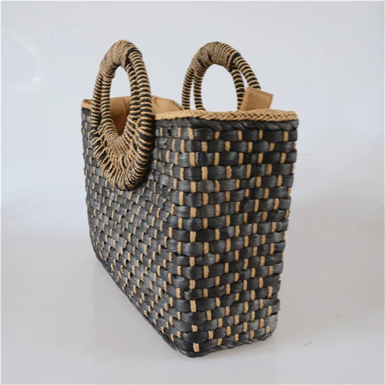 Woven basket with handles on a light gray background