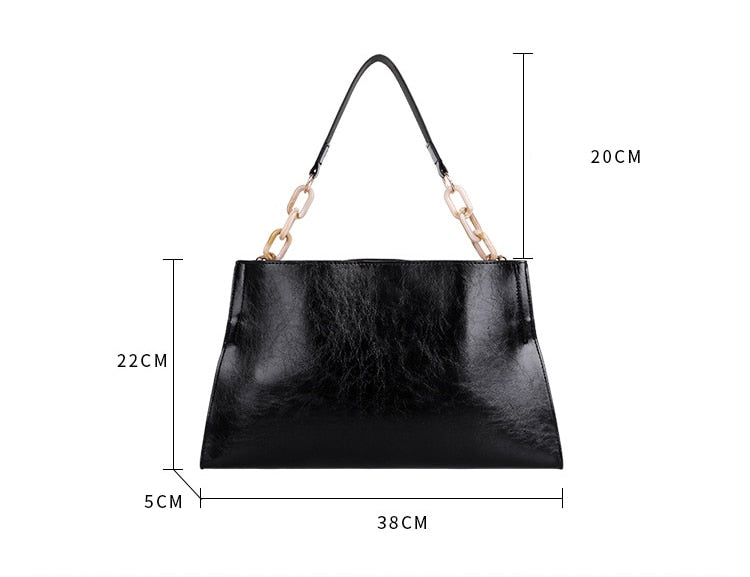 Black handbag with chain handle and dimensions labeled on a white background