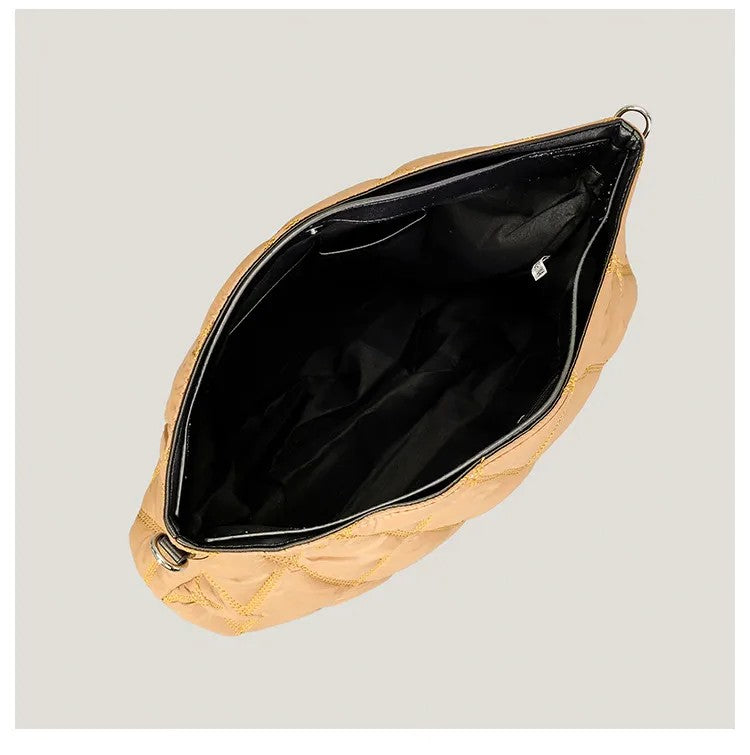 Gold clutch bag with open lid on a light gray background