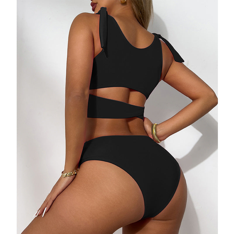 Black bikini set worn by a model on a white background