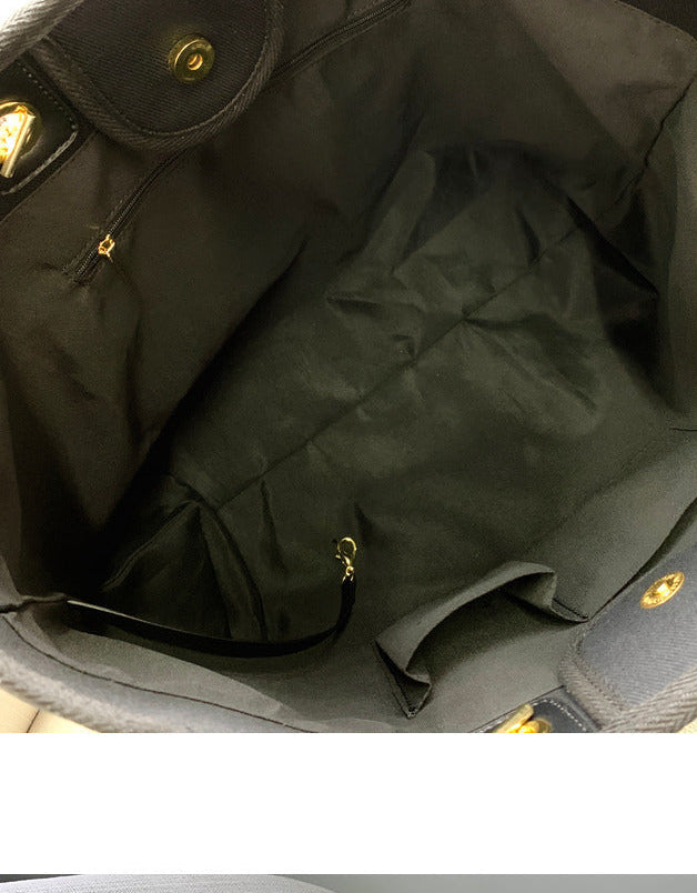 Close-up of a black leather bag with gold hardware, showing the interior and exterior.