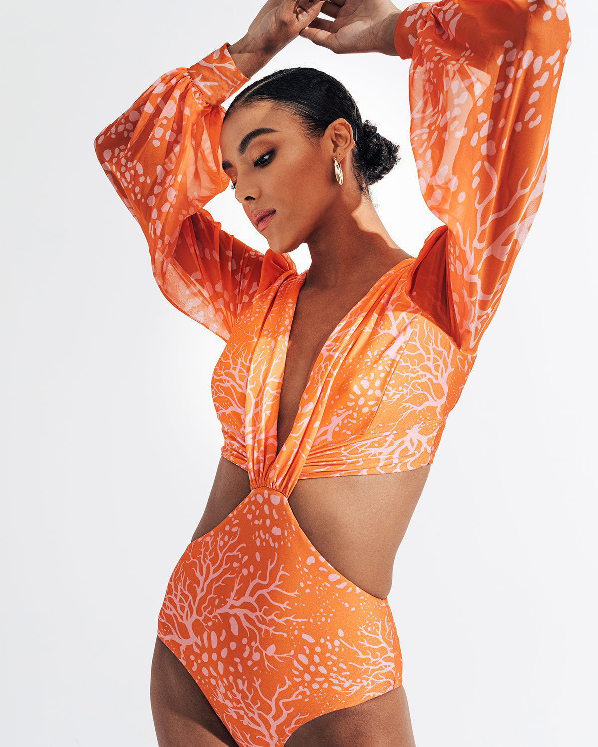 Long‑sleeve printed women’s swimsuit; fitted one‑piece with full sleeves, contoured bust, and vibrant all‑over print for pool and beach.