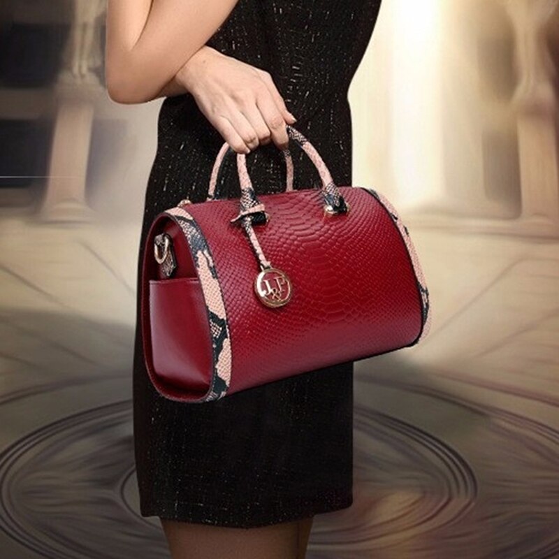 Women’s luxury faux‑leather snakeskin crossbody handbag with top handle and shoulder strap.