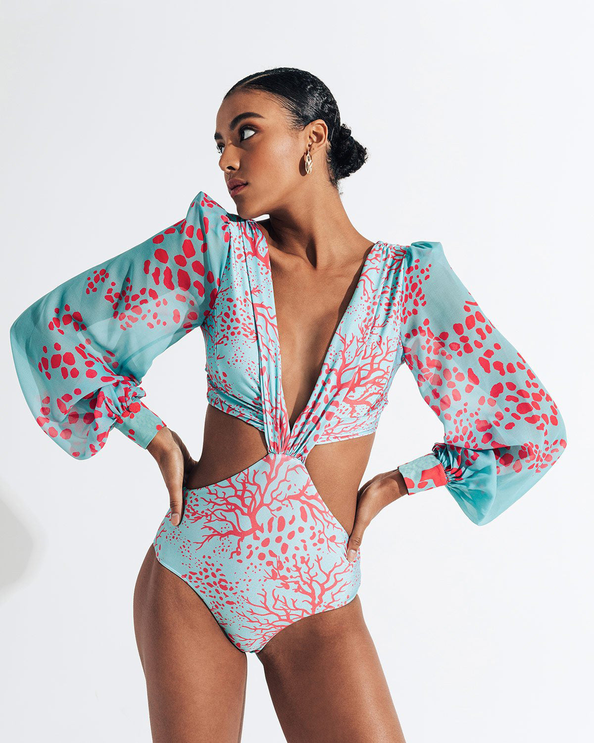 Long‑sleeve printed women’s swimsuit; fitted one‑piece with full sleeves, contoured bust, and vibrant all‑over print for pool and beach.