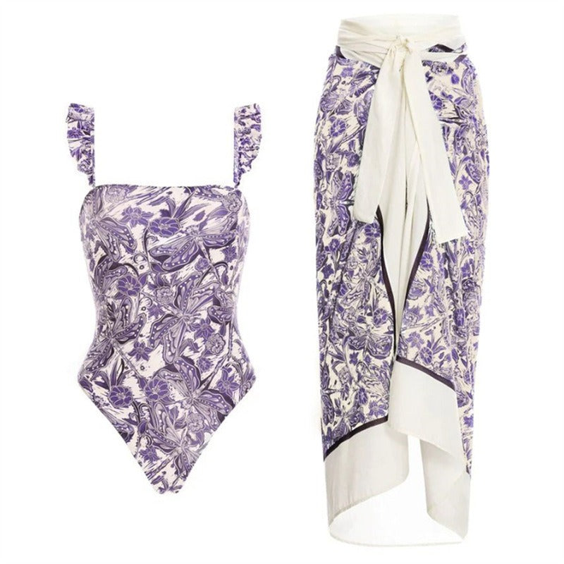 Purple floral swimsuit with a matching skirt coverup on a white background