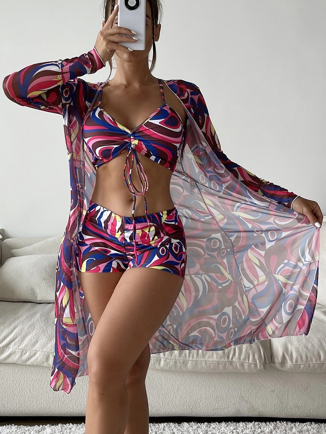 Three‑piece pattern print swimwear set featuring a supportive top, high‑waist bottoms, and coordinating cover or accessory piece; bold tropical foliage pattern and streamlined fit.
