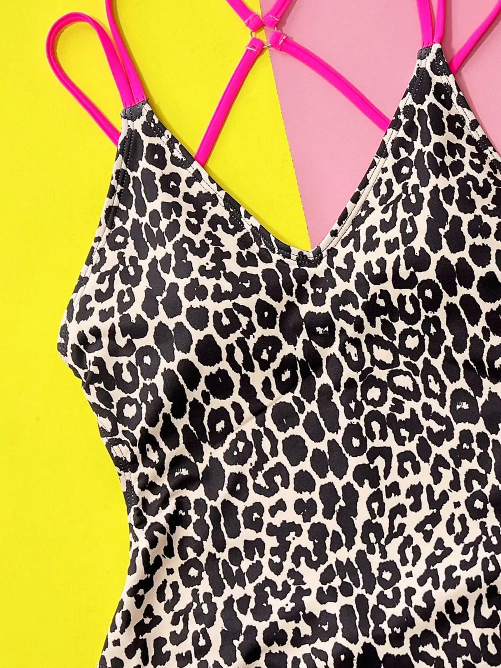 Leopard print one-piece swimsuit against a colorful background