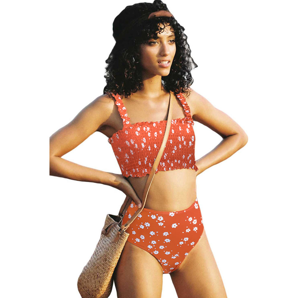 Woman wearing a floral bikini set on a white background