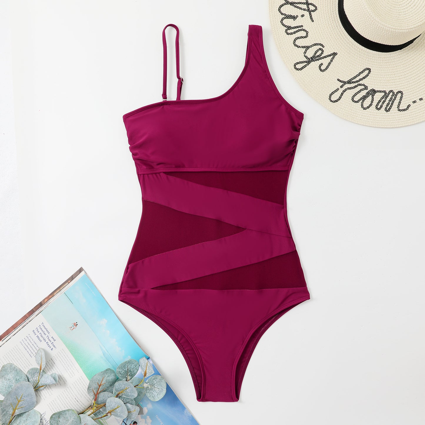 Burgandy swimsuit with a tropical background sold at PeachyBeanz
