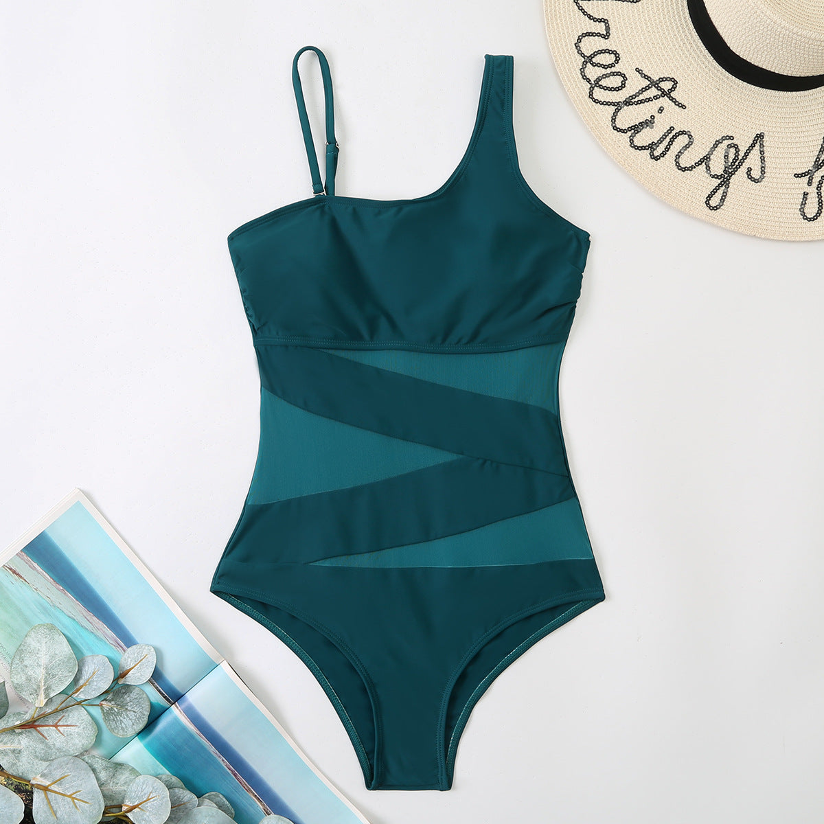 Green swimsuit with a tropical background sold at PeachyBeanz