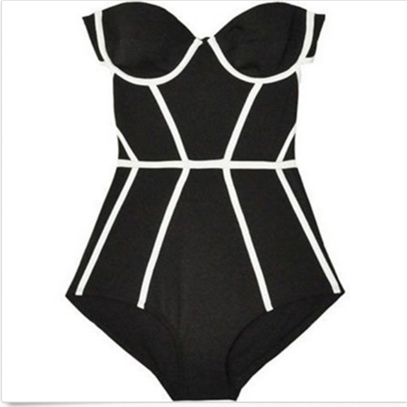 Black swimsuit with white geometric patterns on a white surface