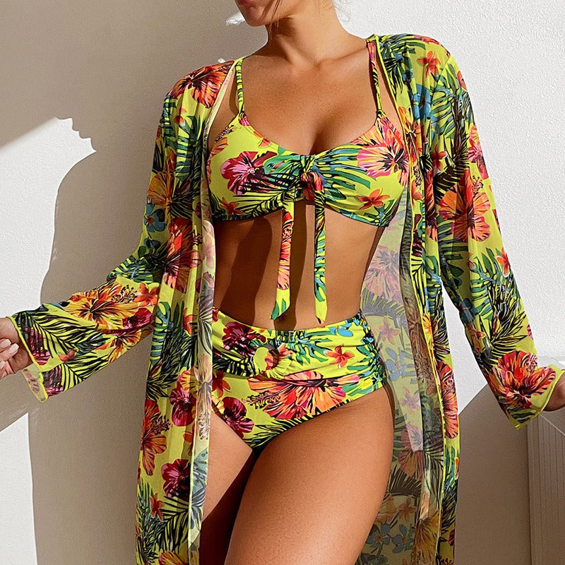 Long sleeve flared cover up with split hem, paired with coordinating bikini and skirt; lightweight printed fabric and relaxed fit.