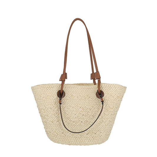 Woven handbag against a white background sold at PeachyBeanz